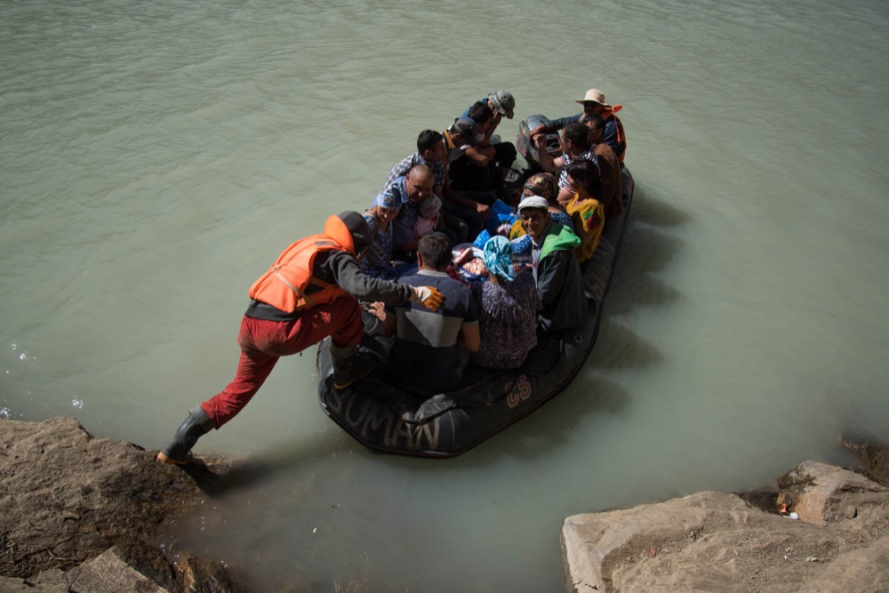 A rubber boat crossing the lake that a mudslide created near Barsem on the Pamir Highway in Tajikistan. © 2015 Carolin Maertens